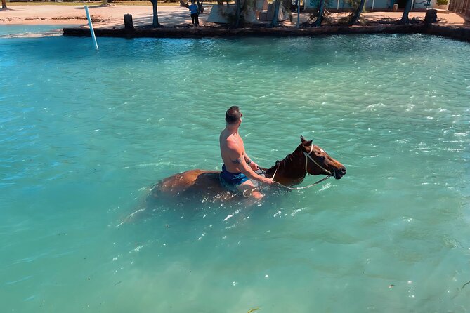 Bamboo Rafting & Horseback Ride n Swim Guided Tour in Montego Bay - Scotchies stop: a jerk-chicken lunch idea, not a guaranteed meal