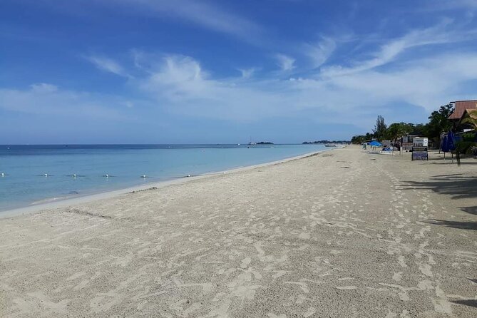 Negril 7 Miles Beach and Rick's Cafe Tour - Rick’s Café: 35-foot cliff views and the sunset show