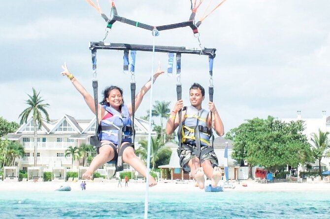 Parasailing, Blue Hole Mineral Spring, Seven Mile Beach - Seven Mile Beach: swimming, snorkeling options, and that 55-foot show